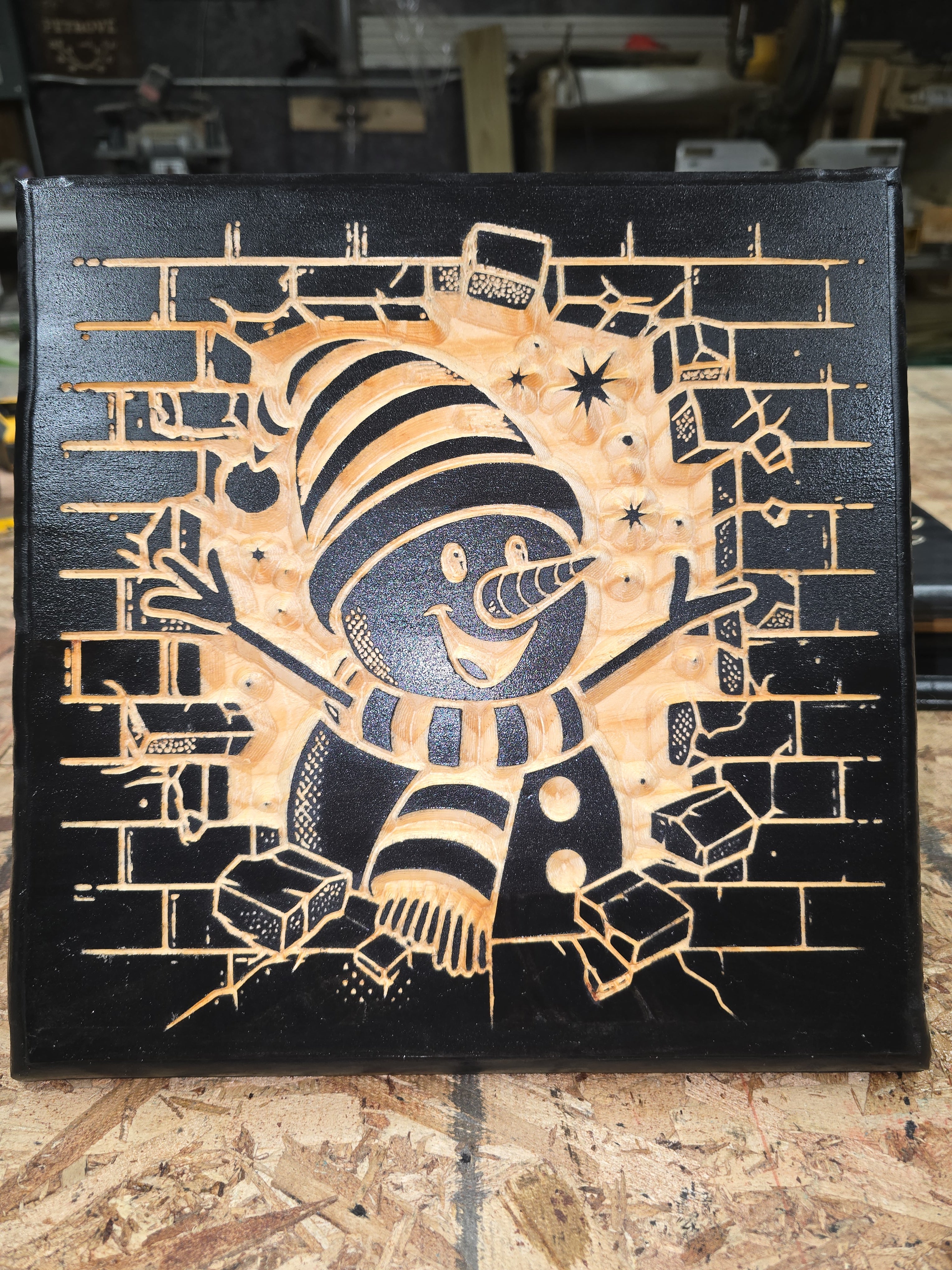 plaque of snowman breaking threw wall