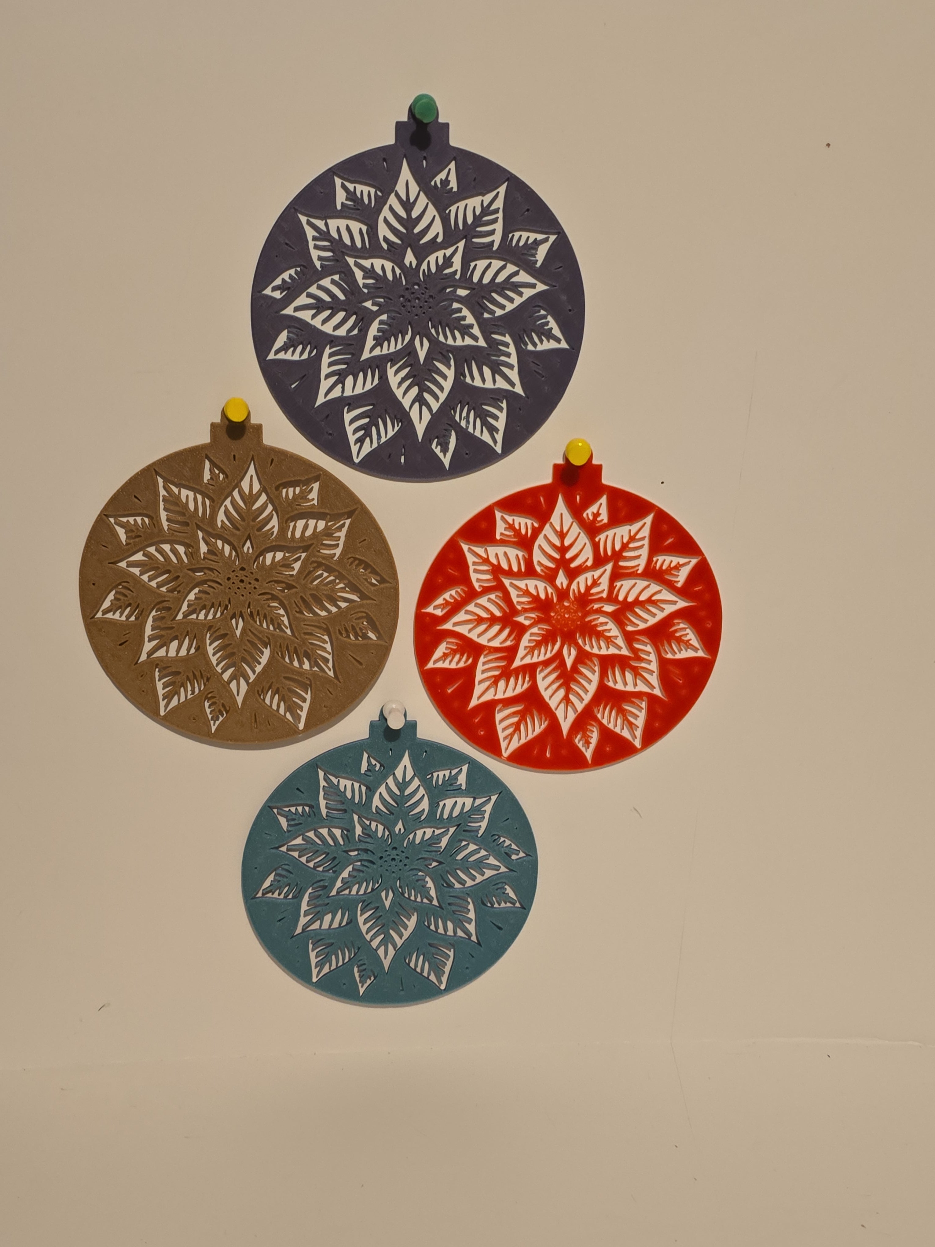 Four Christmas bulbs design in red, blue, brown, and purple on a beige background