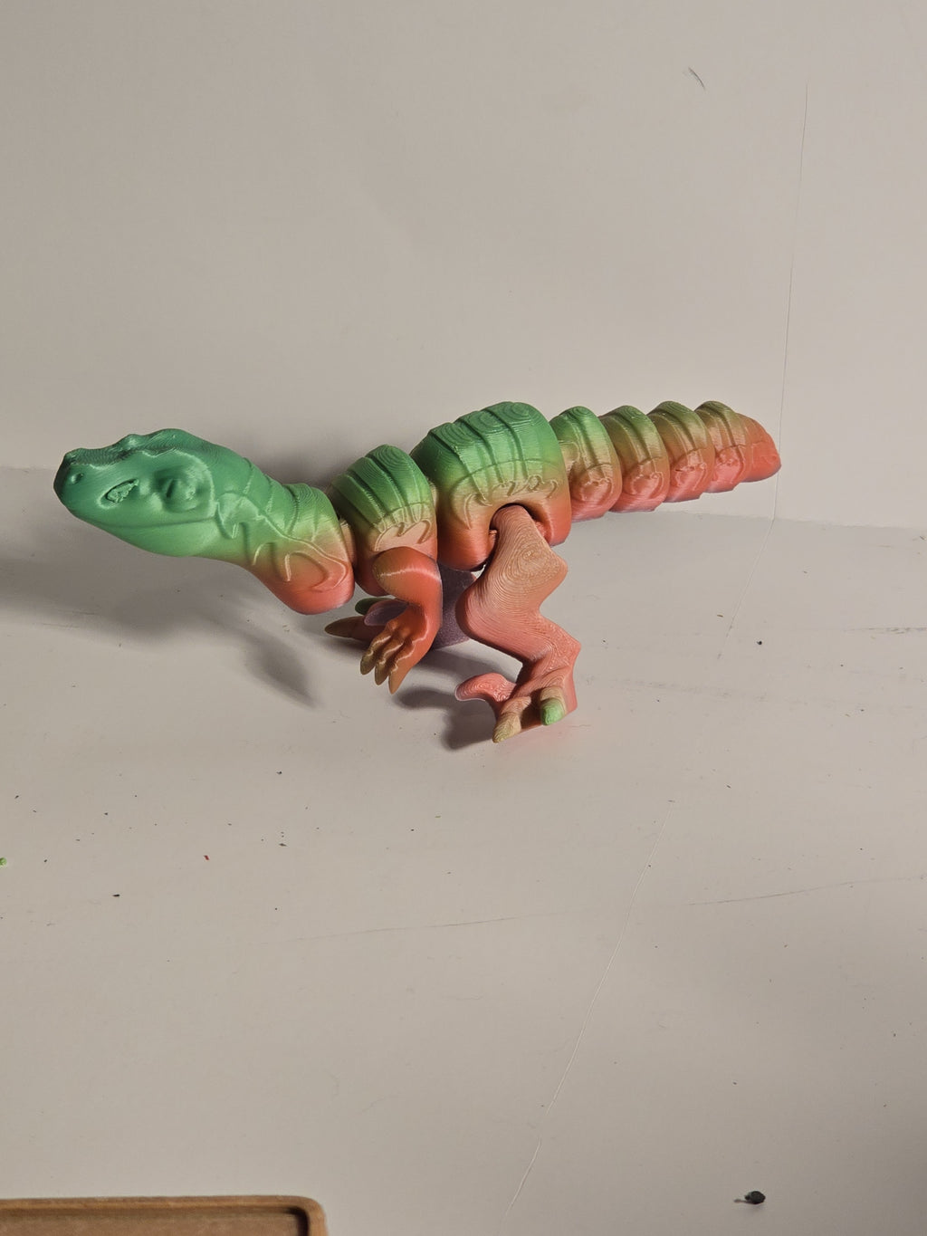 Colorful toy Stegosaurus on a plain background