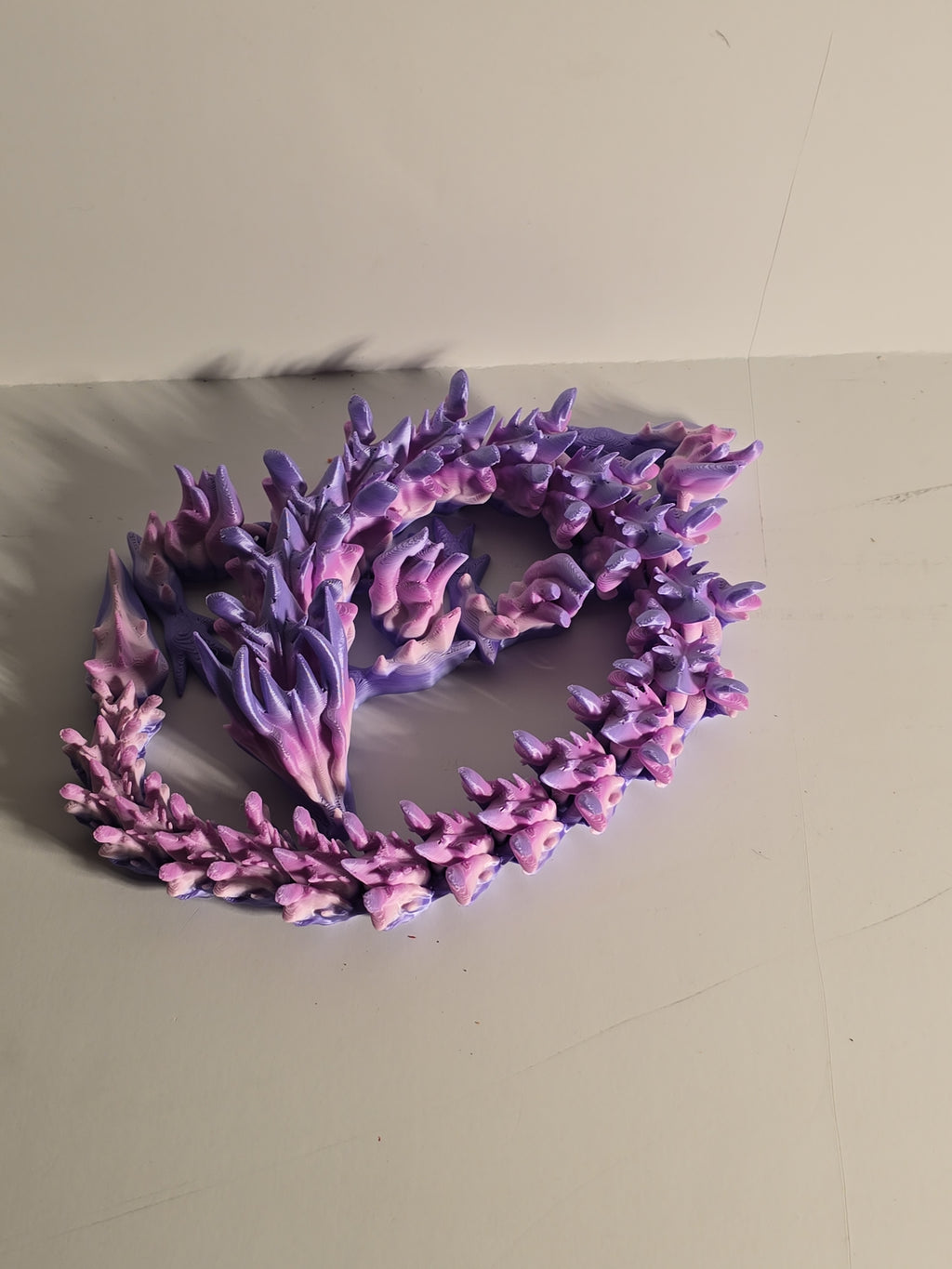 Purple coral-like decorative item on a beige surface