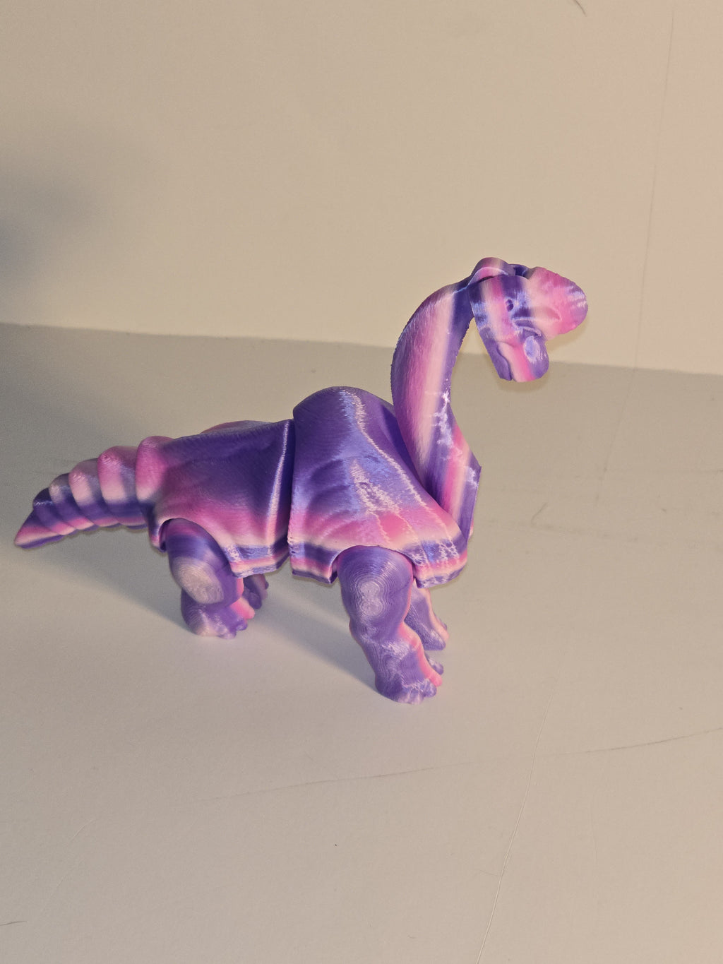 Colorful elephant-shaped object on a plain background