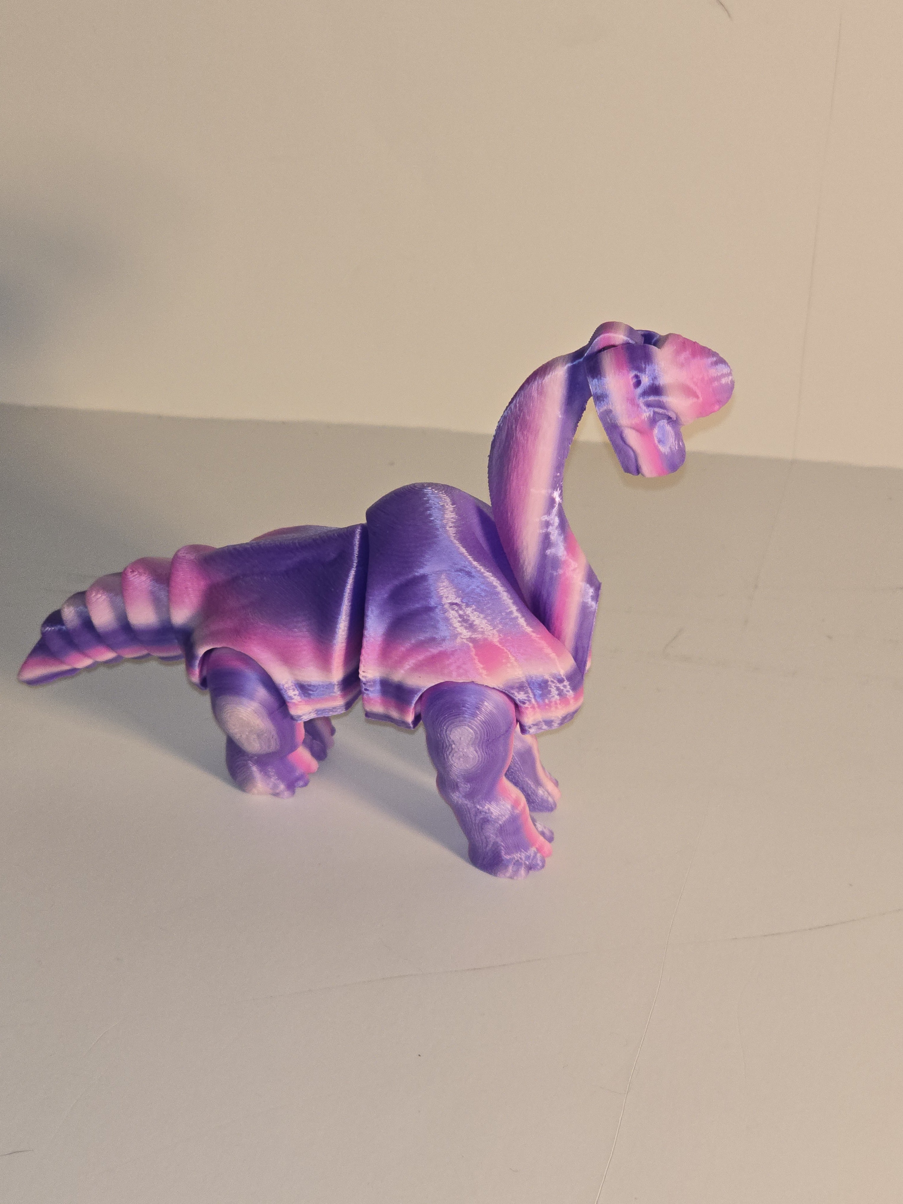 Colorful elephant-shaped object on a plain background