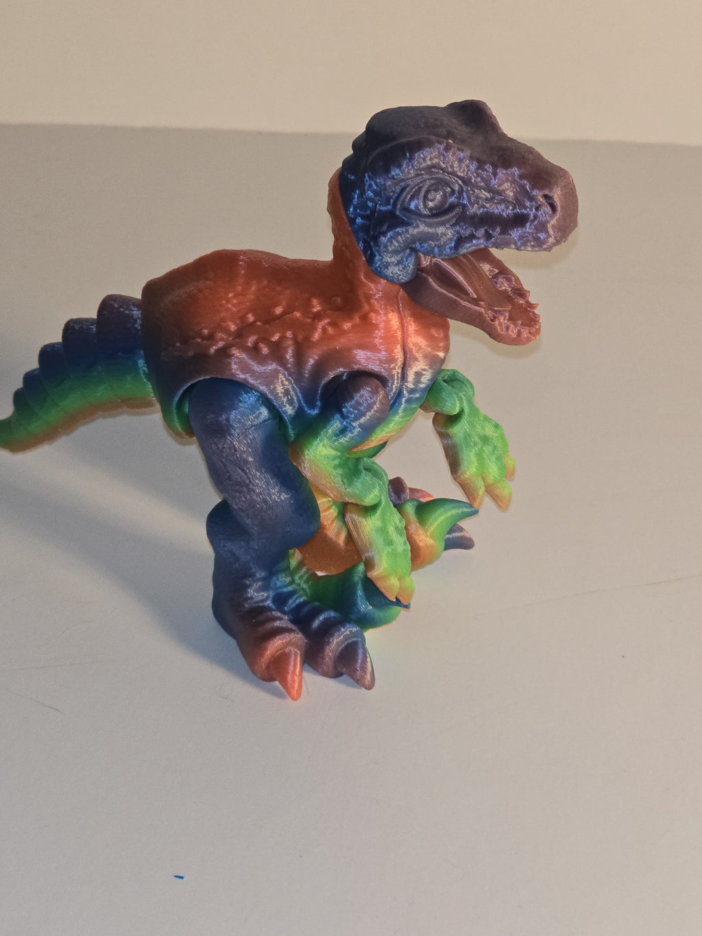 Colorful dragon-shaped object on a plain background