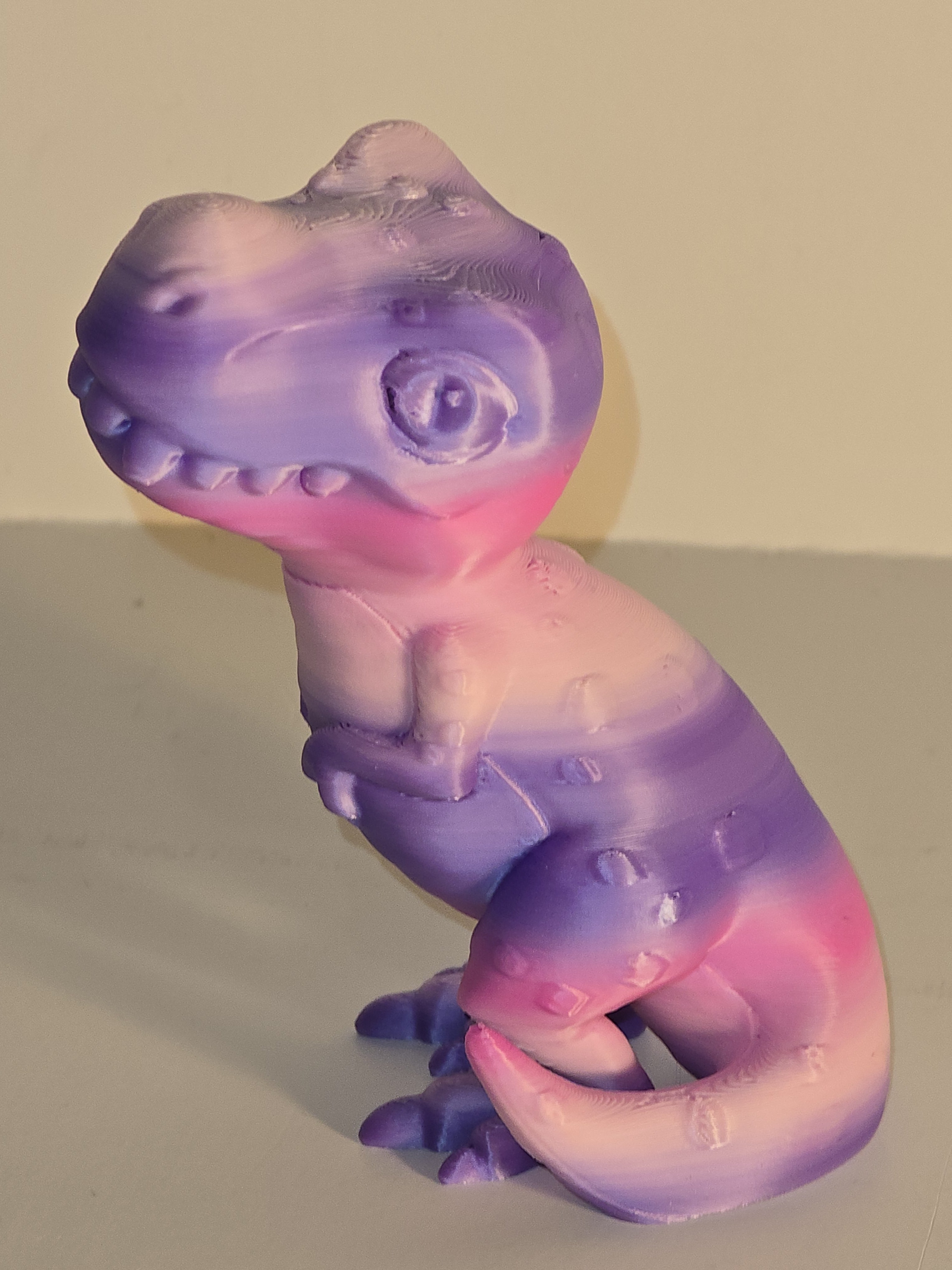 Colorful silicone snake-shaped toy on a beige background